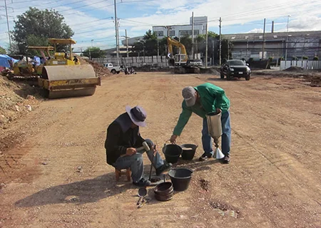 Sand cone field density testing at a construction site