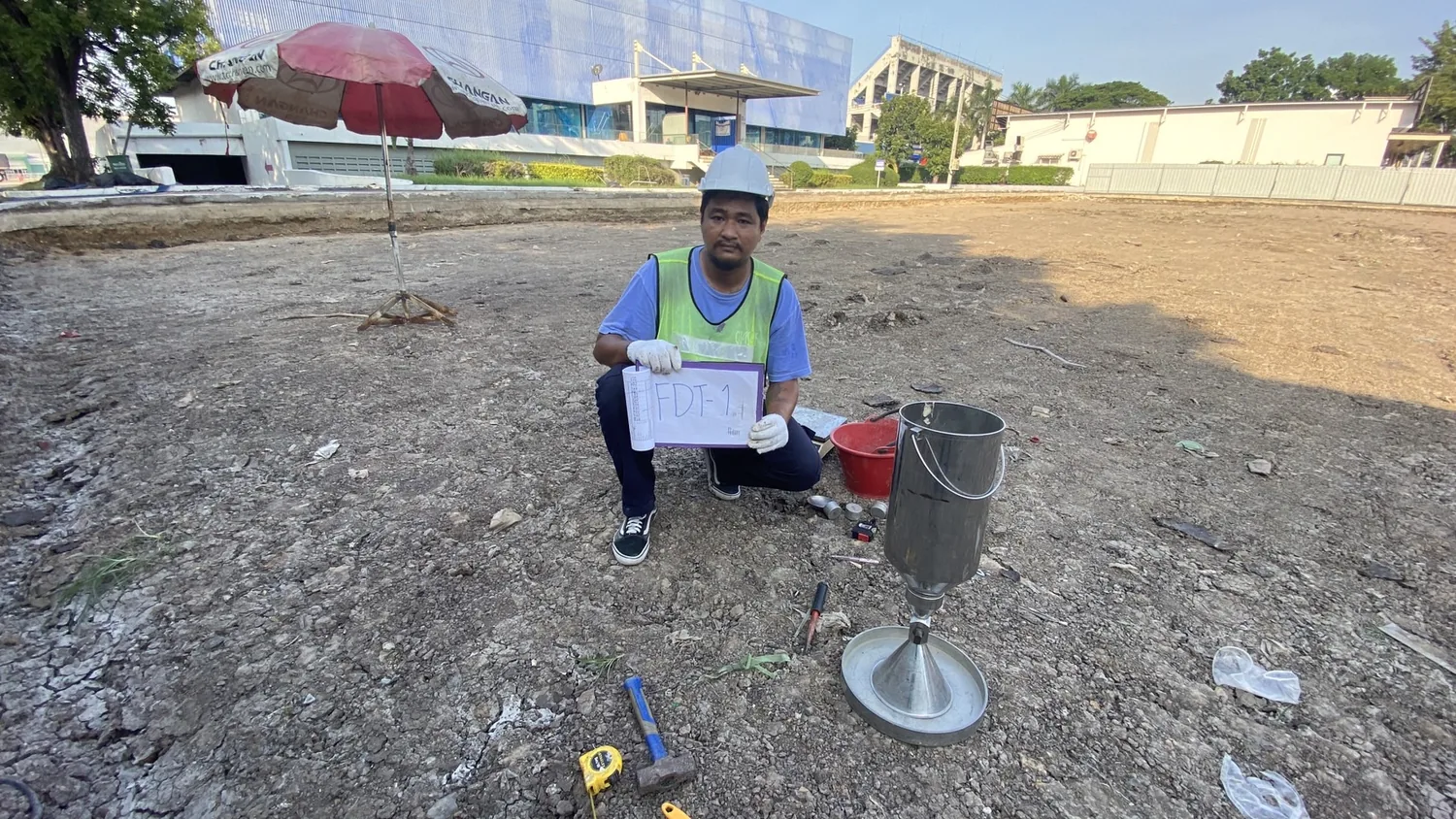 Field testing technician documenting an in-place density test at a construction site